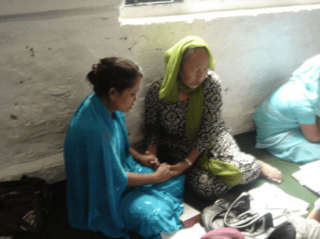 Una, praying with a younger woman.